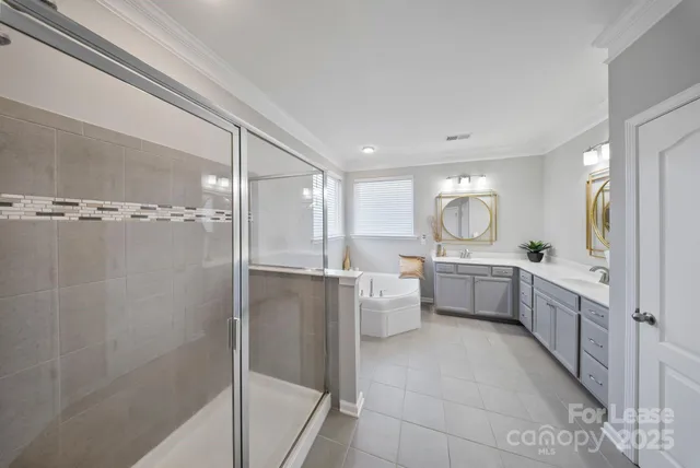 a bathroom with a double vanity sink toilet mirror bathtub and shower