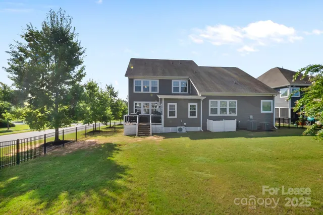 a view of a house with a yard and sitting area