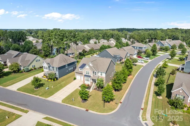 an aerial view of residential houses with outdoor space and street view
