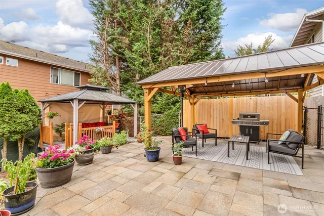 a view of a patio with a table and chairs under an umbrella