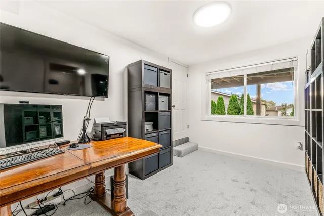 a room with furniture pool table flat screen tv and window