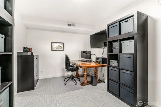 a view of a livingroom with furniture and a refrigerator