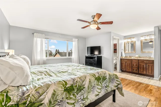 a bedroom with a large bed and a chandelier