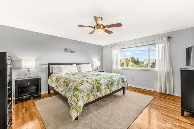 a spacious bedroom with a bed and a chandelier