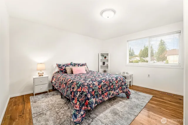 a bed sitting in a bedroom next to a window