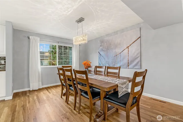 a view of a dining room with furniture window and wooden floor