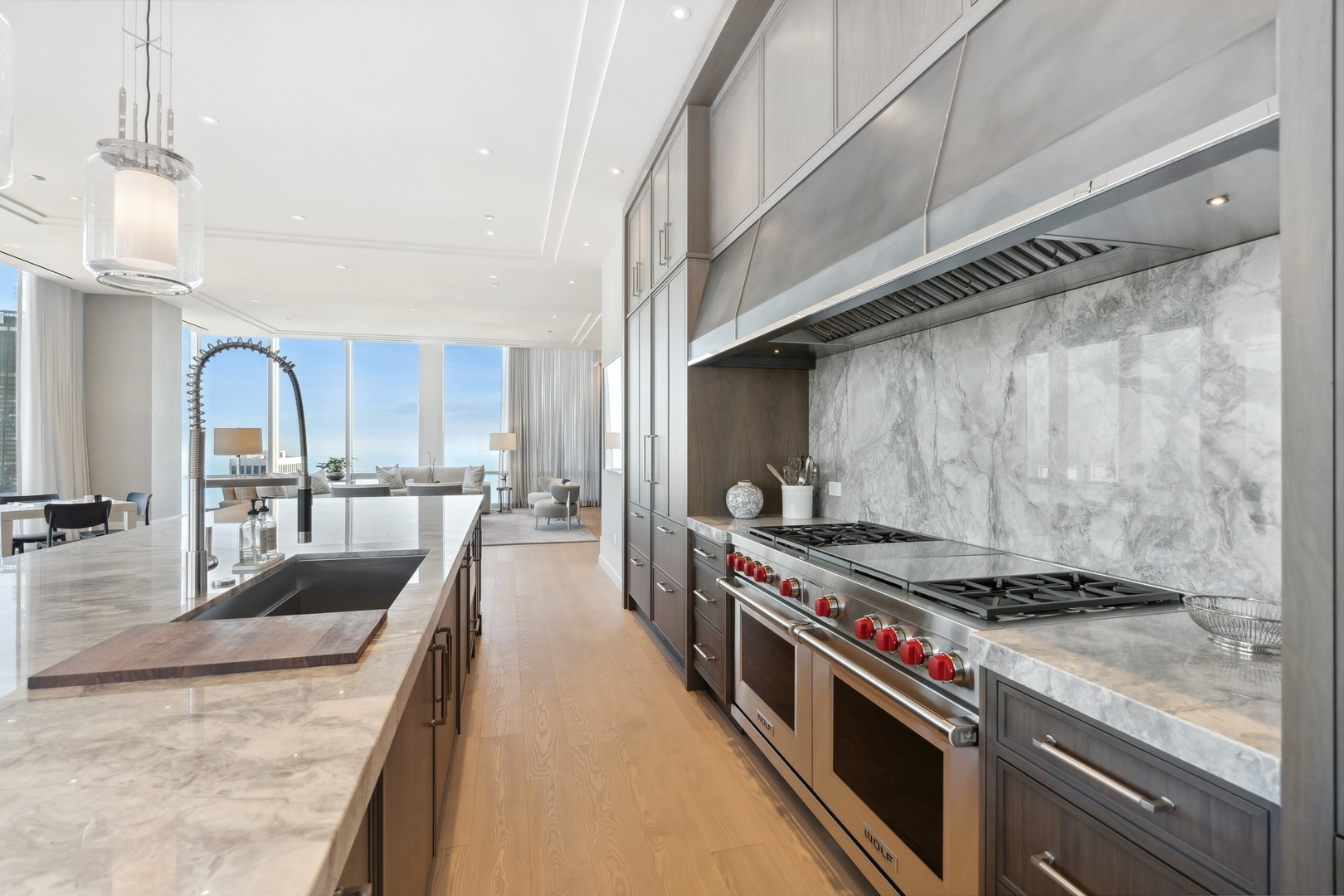 14 West Superior Street, Unit 7100 Chicago, IL 60654 - Photo 11 of 50 a open kitchen with stainless steel appliances granite countertop a stove and a table