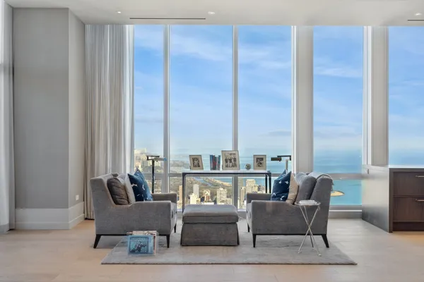 a living room with furniture and large windows