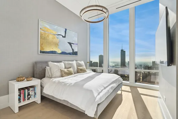 a bedroom with a bed and a large window