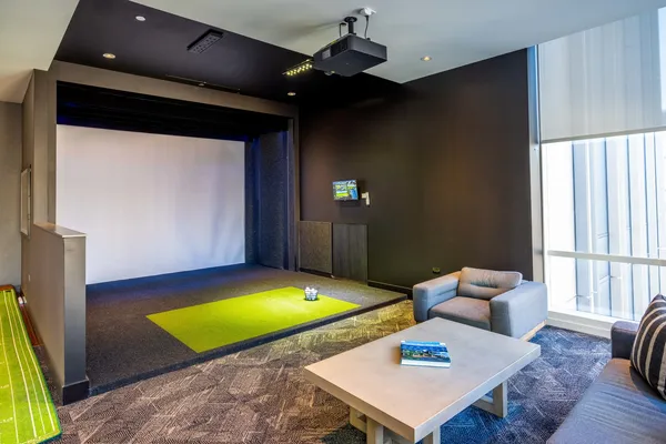 a living room with furniture a rug and a flat screen tv