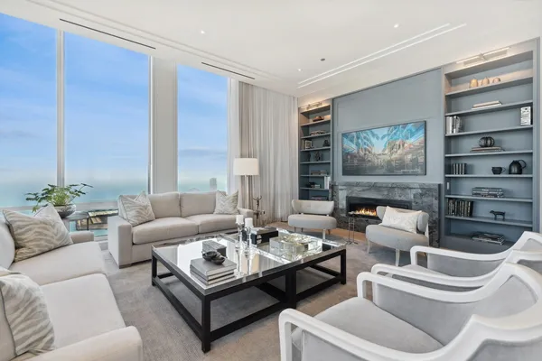 a living room with furniture a flat screen tv and a fireplace
