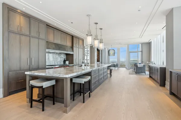 a large kitchen with a table and chairs