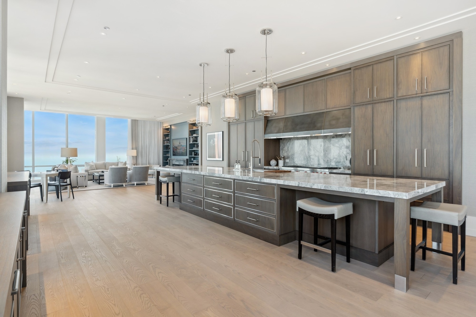 14 West Superior Street, Unit 7100 Chicago, IL 60654 - Photo 9 of 50 a kitchen with stainless steel appliances kitchen island granite countertop a table chairs sink and cabinets
