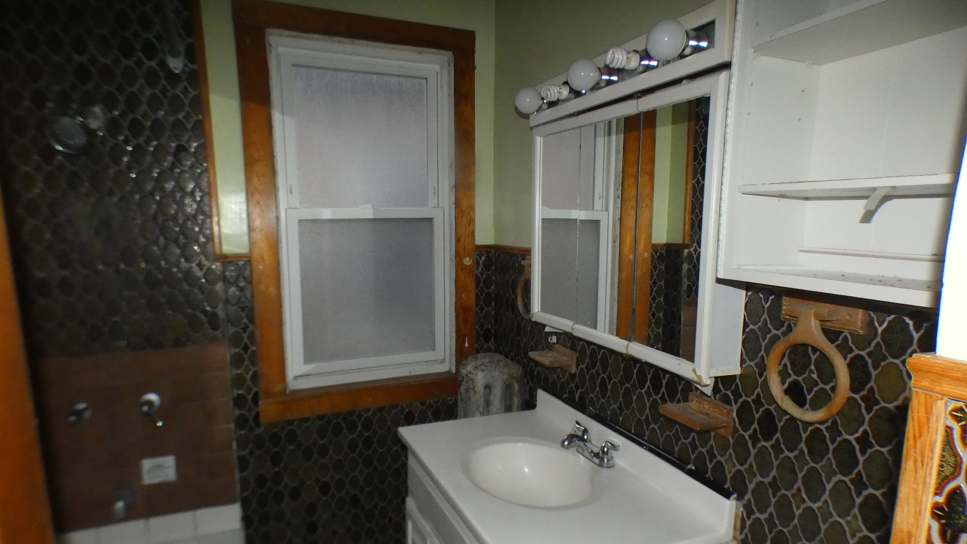 8133 South Loomis Boulevard Chicago, IL 60620 - Photo 12 of 32 a bathroom with a sink and a mirror