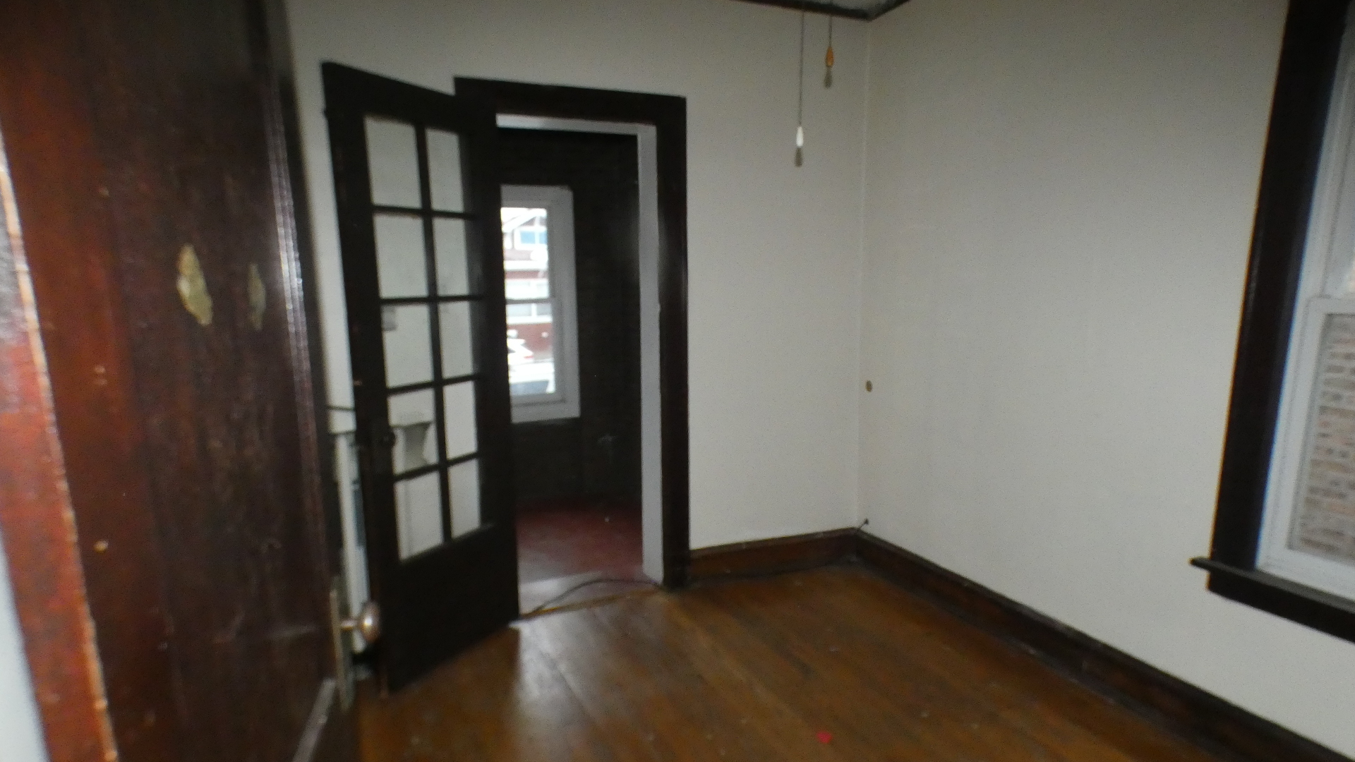 8133 South Loomis Boulevard Chicago, IL 60620 - Photo 6 of 32 wooden floor in an empty room with a window