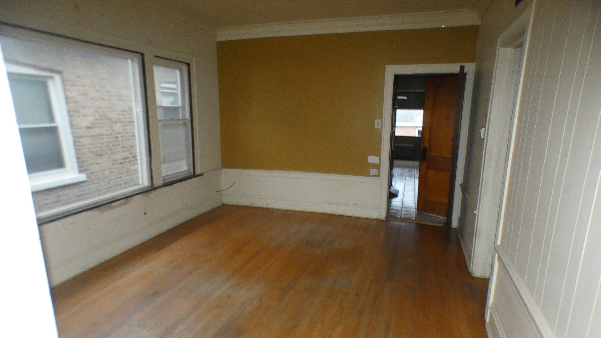 8133 South Loomis Boulevard Chicago, IL 60620 - Photo 8 of 32 a view of an empty room with glass door and a window
