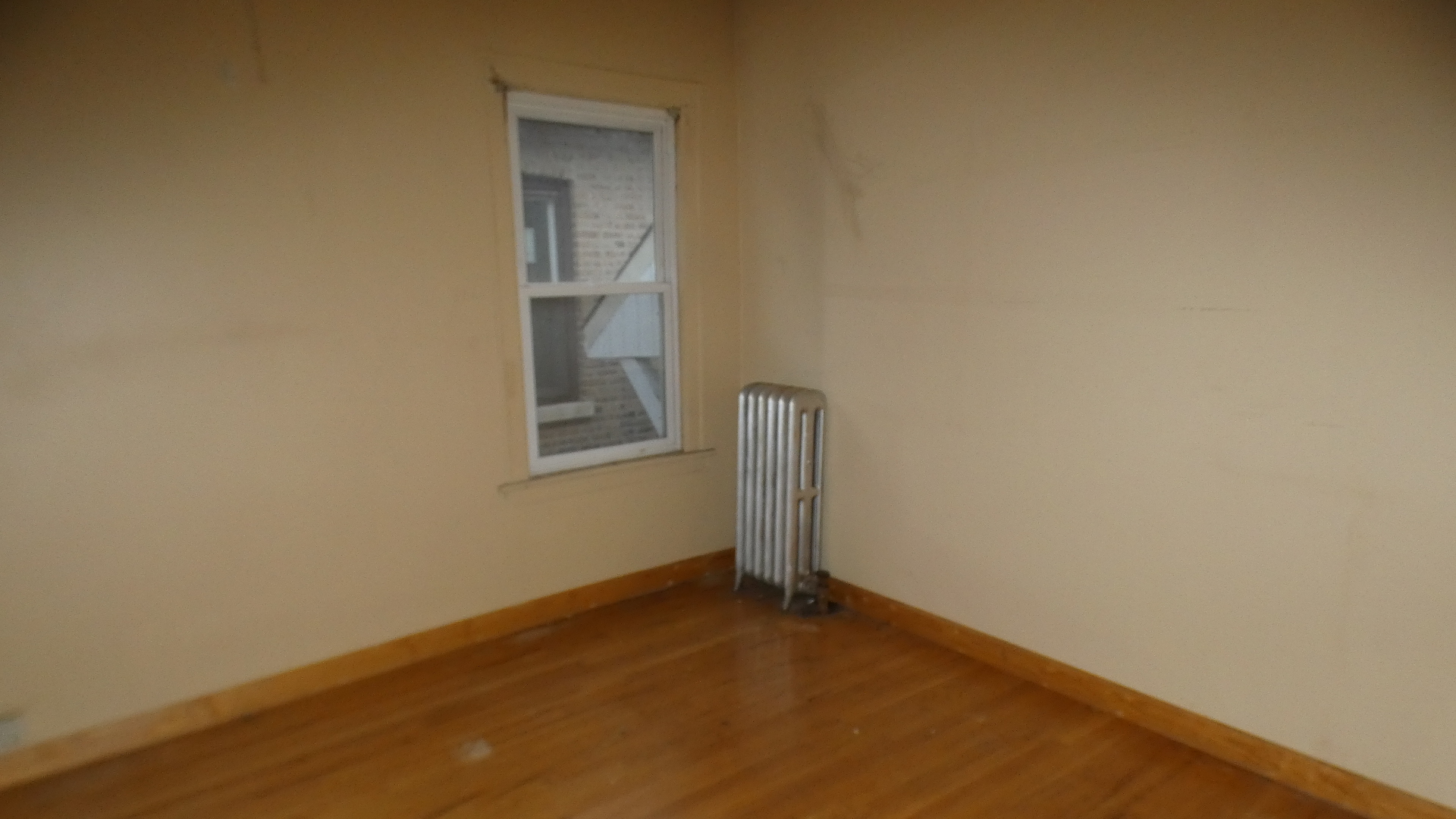 8133 South Loomis Boulevard Chicago, IL 60620 - Photo 9 of 32 a view of a small space with wooden floor and a window