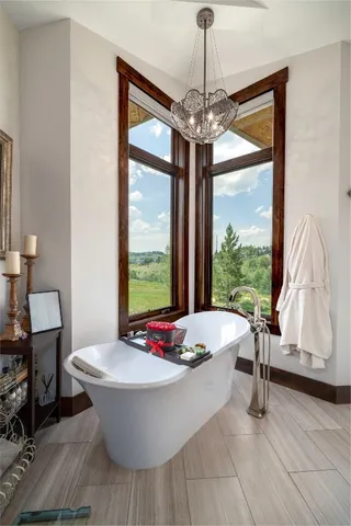a spacious bathroom with a double vanity sink a mirror and a shower