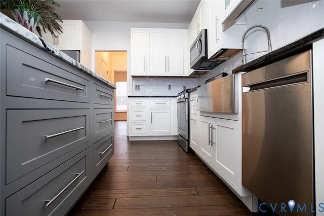 a kitchen with stainless steel appliances a refrigerator and cabinets