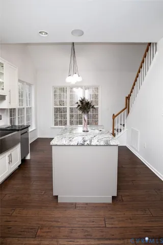a view of living room with wooden floor and chandelier