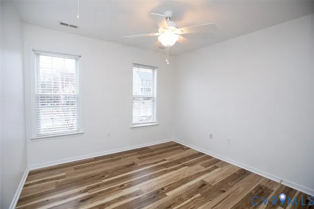 wooden floor in an empty room with a window
