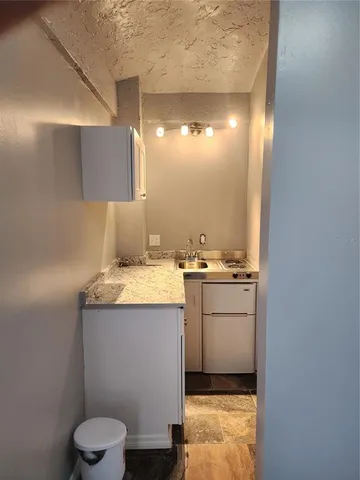 a room with a sink and cabinets