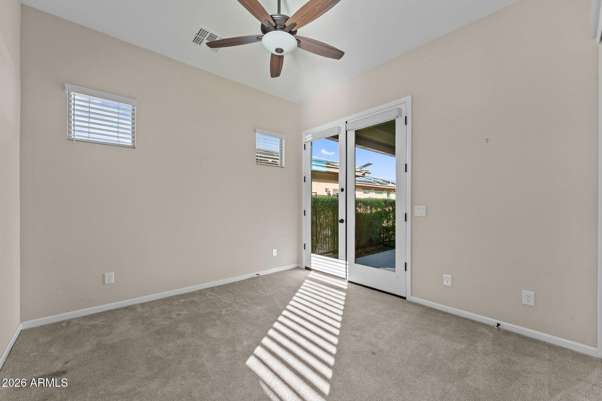 3675 Gold Ridge Road Wickenburg, AZ 85390 - Photo 26 of 58 an empty room with chandelier fan and windows