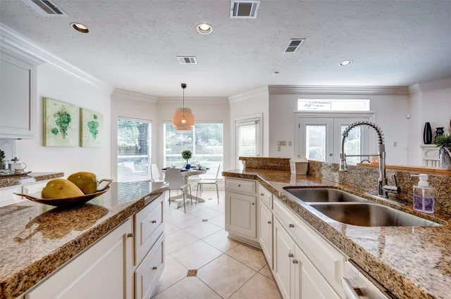 a kitchen with a sink and living room