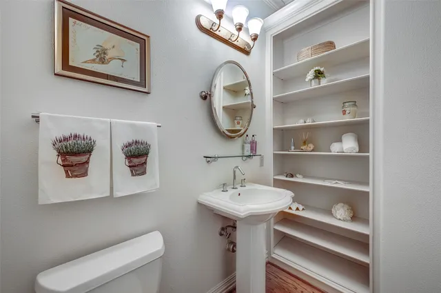 a bathroom with a toilet a sink and a mirror