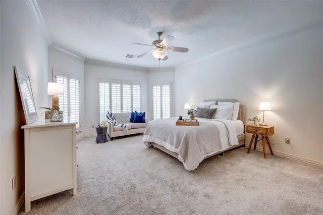 a spacious bedroom with a bed couch and a large window