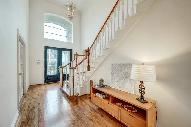 a view of entryway and hall with wooden floor