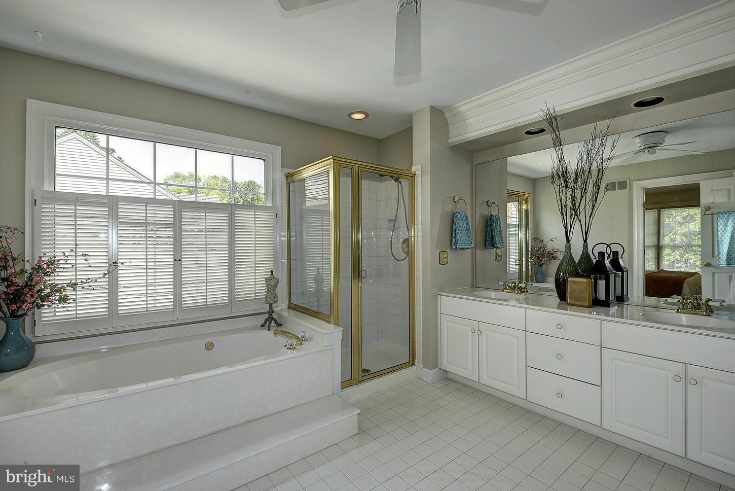 9730 Hidden Valley Road Vienna, VA 22181 - Photo 16 of 30 a spacious bathroom with a tub sink shower and mirror