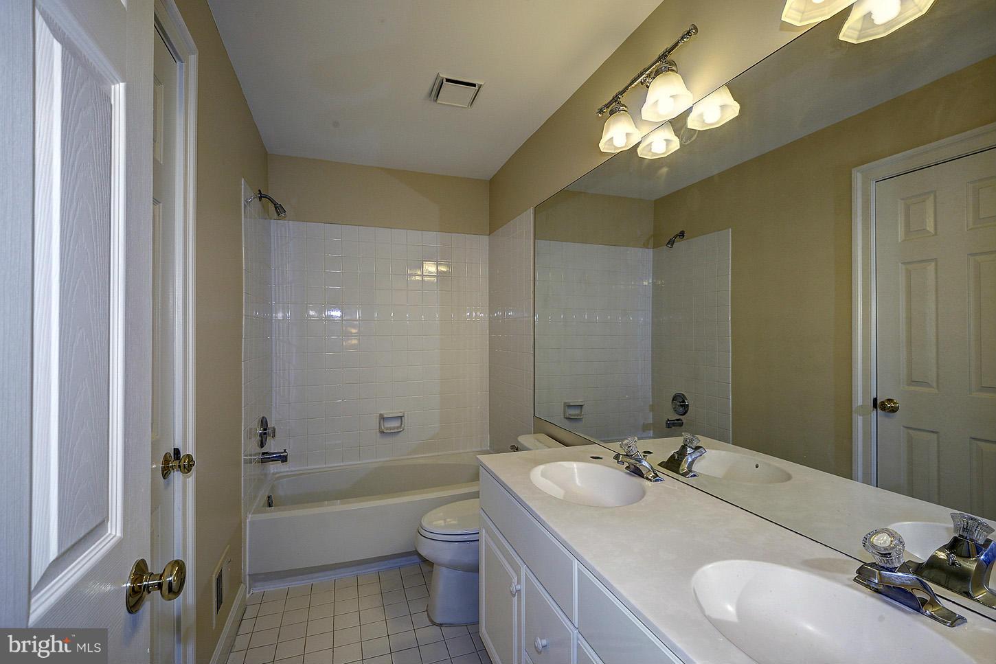 9730 Hidden Valley Road Vienna, VA 22181 - Photo 21 of 30 a bathroom with a sink double vanity granite tub and shower