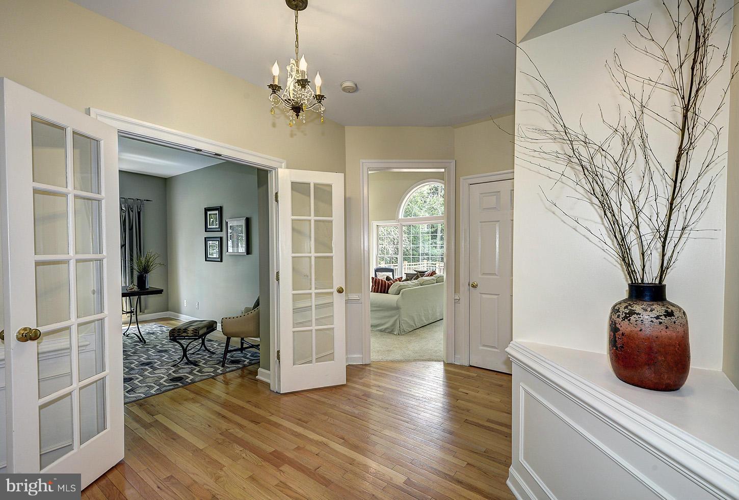 9730 Hidden Valley Road Vienna, VA 22181 - Photo 6 of 30 a living room with furniture and a chandelier