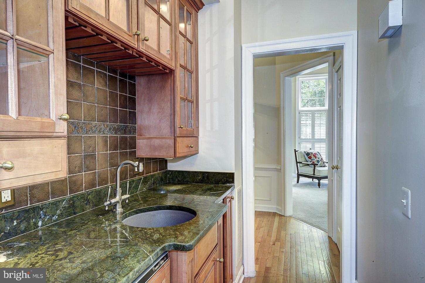 9730 Hidden Valley Road Vienna, VA 22181 - Photo 10 of 30 a bathroom with a granite countertop sink a mirror and vanity