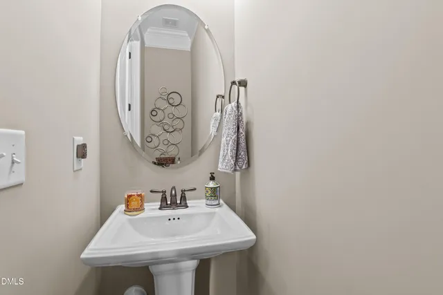 a bathroom with a sink and mirror