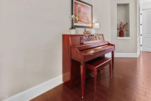 a view of a hallway with wooden floor and a cabinet