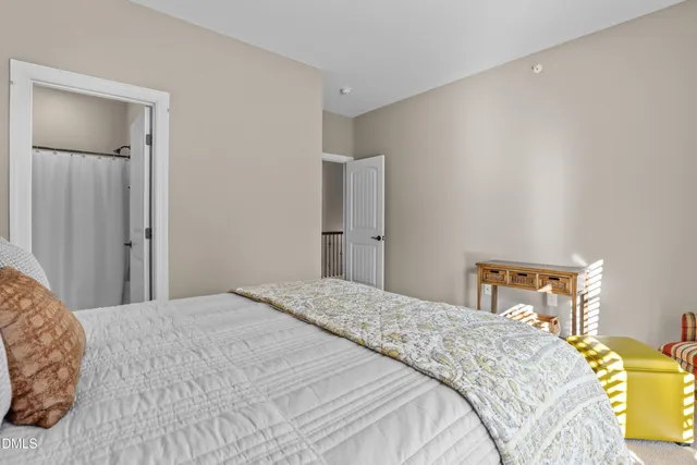 a bedroom with a bed and a lamp