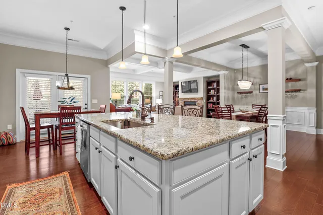 a kitchen with center island table and chairs