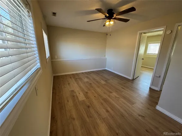 a view of an empty room and wooden floor