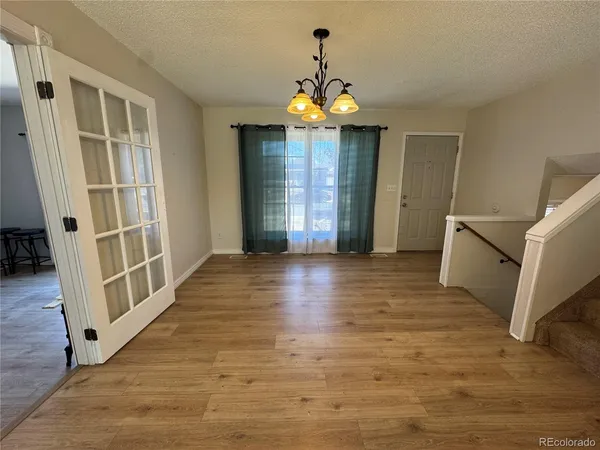 a view of a room with wooden floor and stairs