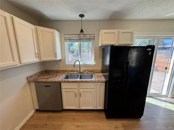 a kitchen with stainless steel appliances granite countertop a refrigerator a sink a stove a microwave and island