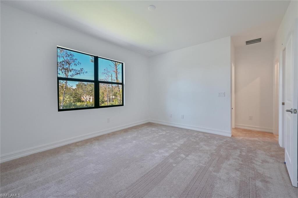 7611 Morgan Way Naples, FL 34119 - Photo 12 of 26 an empty room with windows