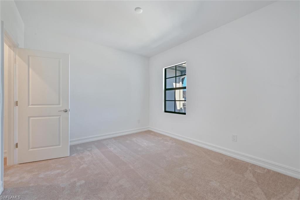 7611 Morgan Way Naples, FL 34119 - Photo 17 of 26 an empty room with windows