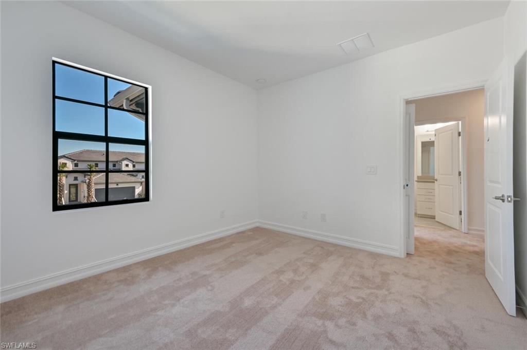 7611 Morgan Way Naples, FL 34119 - Photo 18 of 26 an empty room with windows and closet