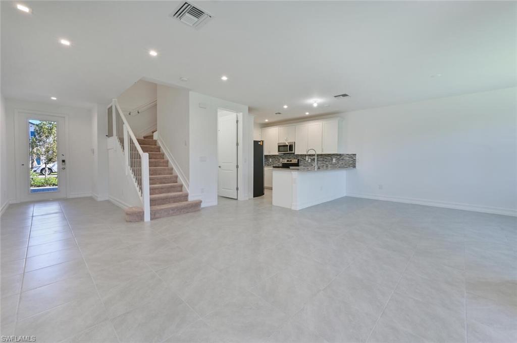 7611 Morgan Way Naples, FL 34119 - Photo 2 of 26 a view of a kitchen with a sink and a refrigerator