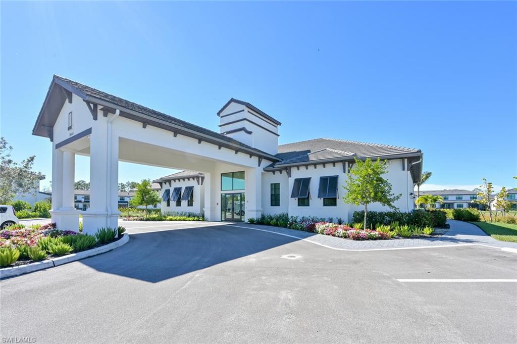 7611 Morgan Way Naples, FL 34119 - Photo 23 of 26 a front view of a house with a yard and outdoor seating