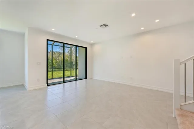 a view of an empty room with glass door