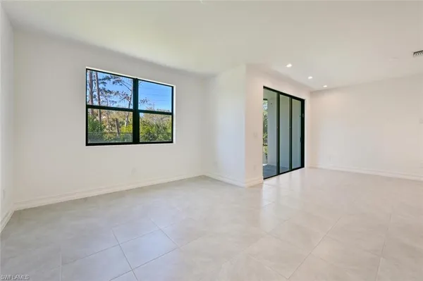 a view of an empty room with glass door