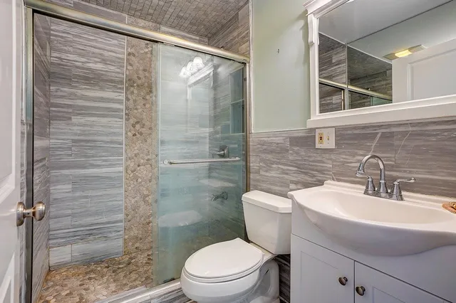 a bathroom with a toilet a sink and shower